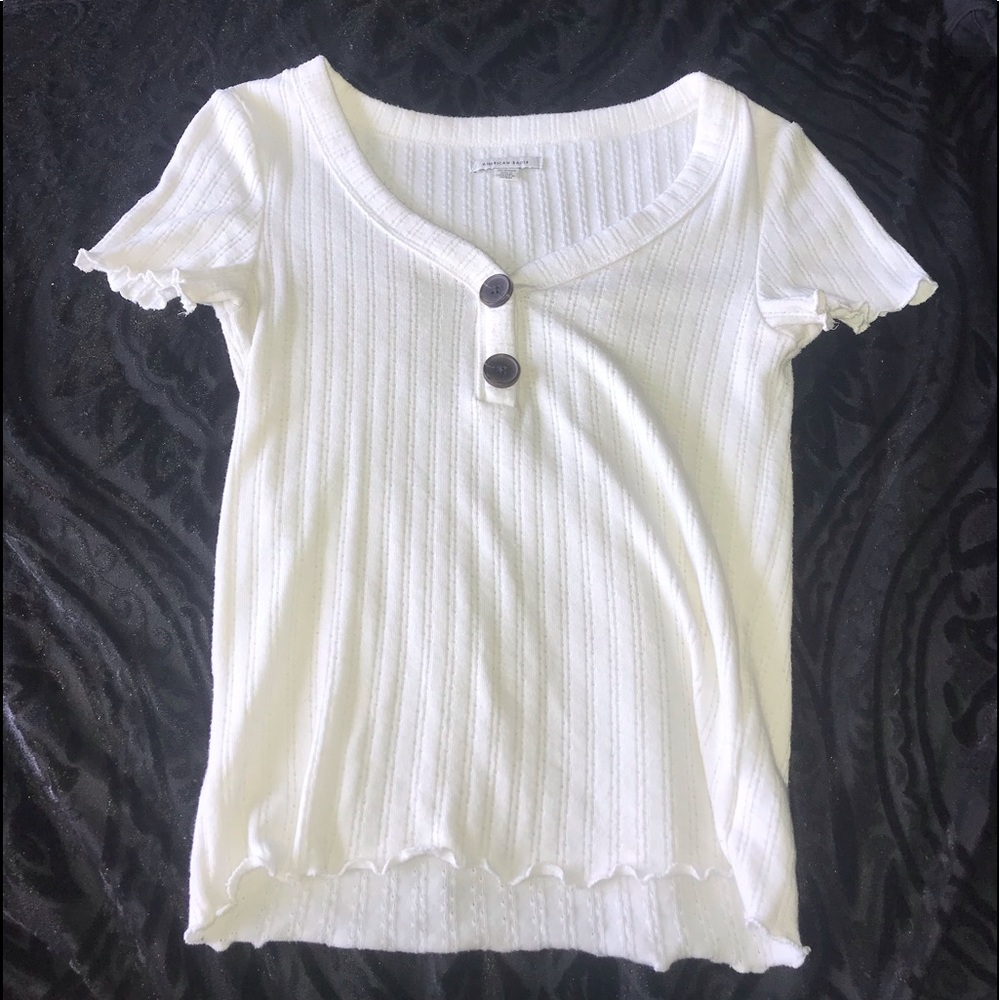White top with brown buttons